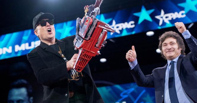 Elon Musk brandishes a chain saw given to him by President Javier Milei of Argentina, to his right, at the Conservative Political Action Conference in Maryland in February. 