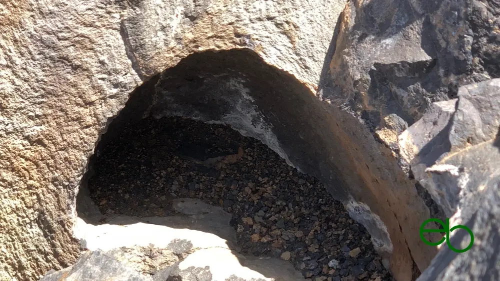 Hole with sediments in an old lava flow